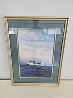 Framed watercolour painting showing the full artwork depicting a boat on water under sky.