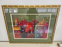 Full view of the framed watercolour painting depicting colourful architectural forms.
