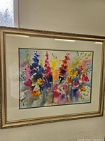 Full view of the framed watercolour painting showing an abstract floral arrangement with varied bright colors.