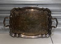 Full view of antique silver plated serving tray showing overall shape, handles and patina.