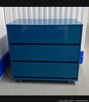 Front view of the modern glossy teal blue chest dresser with three drawers