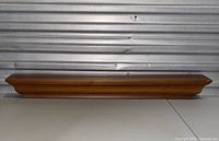 Front view of the Pottery Barn wooden wall shelf showing the shape and finish.