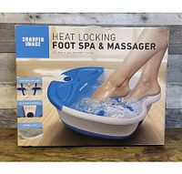 Box of Sharper Image Heat Locking Foot Spa & Massager showing branding and product usage image with feet inside the spa.