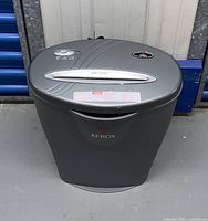 Front view of the gray Xerox paper shredder with top controls and paper slot visible