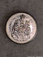 Close-up photo of the 1960 Canadian 50-cent coin showing the Canadian Coat of Arms