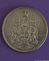 Front side of the 1965 Canadian 50-cent silver coin showing detailed coat of arms with inscriptions and coin edge.