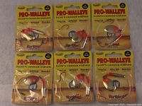 Six new in packaging Pro-Walleye Float'n Crawler Harness fishing lures, front view showing labels and lure design.
