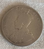 Photo showing the obverse of the silver Canadian 50 cent coin with King George V's bust in profile.