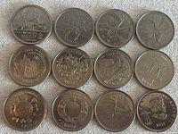 Top view of 12 Canadian quarters laid out with varied designs and years, mostly 1999.