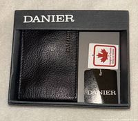 Danier black leather card holder in box showing brand and tags
