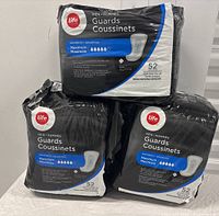 Three packs of Life Brand Men’s Guards stacked, showing front packaging with brand and product details.