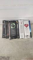 Front view of the eight DVD box sets arranged side by side showing spine titles including The X-Files Season 7, Alien (multiple discs), Fringe Season 1, Superman 1-3 box set.