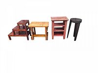 Four novelty side tables arranged in a row on white background: three-tier stepped table, rectangular table, three-shelf table, and round table.