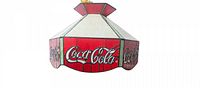 Front view of stained glass Coca-Cola chandelier lamp showing Coca-Cola logos on red panels.