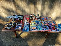 Photo of the entire collection showing model ship, action figures, magazines, and assorted Star Trek items on a table.