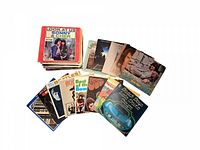 Photo of 46 vintage vinyl records showing stacked albums and some laid flat including The Beatles, The Beach Boys, Sonny & Cher, Jimi Hendrix and more.