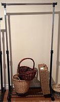 Clothes rack with four baskets placed beneath, showing full structure and basket details for the lot.