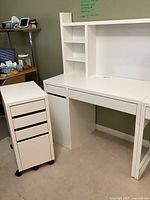 Full set: desk, hutch, mobile file cabinet against green wall
