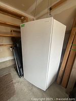 Closed exterior view of white Frigidaire freezer showing front and brand logo