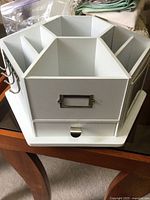 White wooden organizing caddy with multiple compartments and a drawer, designed for bead storage.