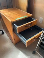 Wooden filing cabinet with 3 drawers, two drawers open showing interior compartments on metal rails