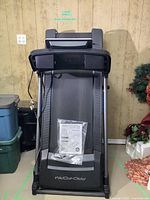 Front view of treadmill upright showing running deck and manual bag