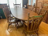 Full view of the solid oak oval table with six chairs around it