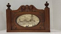 Front view of antique carved wood picture frame with oval architectural print of Eastern Block Departmental Buildings, Ottawa