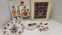 Group shot of Canada Centennial plate, Expo 67 bowl, Spirit of Canada book, two matchboxes with maple leaf design.