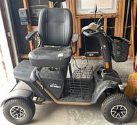Right-side view showing overall scooter, seat, baskets and wheels