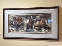Full view of framed print showing four wolf pups and frame