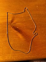 Full view of the chain laid flat on wood surface