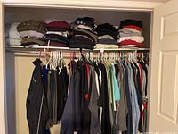 Overview of hanging garments and folded stacks of clothing