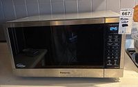 Front view of Panasonic microwave oven with stainless steel finish and digital control panel.
