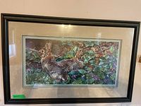 Full view of framed print showing rabbits among violets