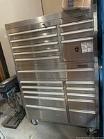 Front view of entire two-piece tool chest showing drawers and caster wheels