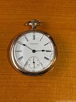 Full front view of watch showing dial, hands, case, crown and bow