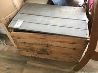 Full view of the wooden shipping box with removable lid showing overall condition and construction.