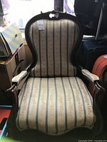Frontal view of the wooden framed parlour chair with striped upholstery showing overall condition.