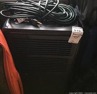 Front view of black Danby dehumidifier with extension cord on top and MaxSold tag.