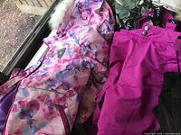 Children's snow coat and snow pants, colorful floral coat and bright pink pants with suspenders.