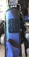 Blue Top-Flite golf bag with embossed logo and multiple compartments