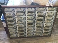 Full view of framed uncut banknote sheet