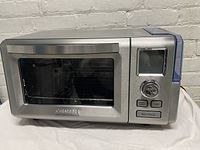 Front view of closed oven showcasing stainless steel exterior, door and control panel