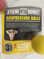 Single yellow high density acupressure ball on top of product info card showing use and benefits.