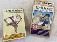 Photo of the front packaging of Gentle Leader Medium Black Headcollar showing dog wearing the collar and size chart.