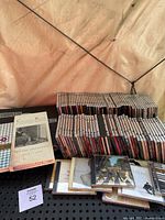 Photo shows a large quantity of music CDs stacked and lined up, including a boxed set named 'Classic Kids The Dot Collection 1968-1978' and multiple individual CD jewel cases.