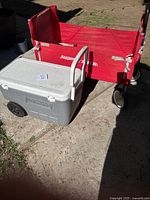 Full view of grey Coleman cooler in front of red Radio Flyer folding wagon