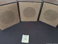 Three Valcom V-1222 speakers arranged side by side displaying the front fabric-covered speaker grille with circular driver outline visible.