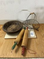 Photo of all four items together showing the dough bowl, wire basket with wooden handle, and two wooden rolling pins with red and green handles.